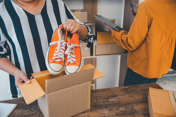 Online small business owner is packing products for customers according to their orders online-Shopping online concept. - 写真・画像
