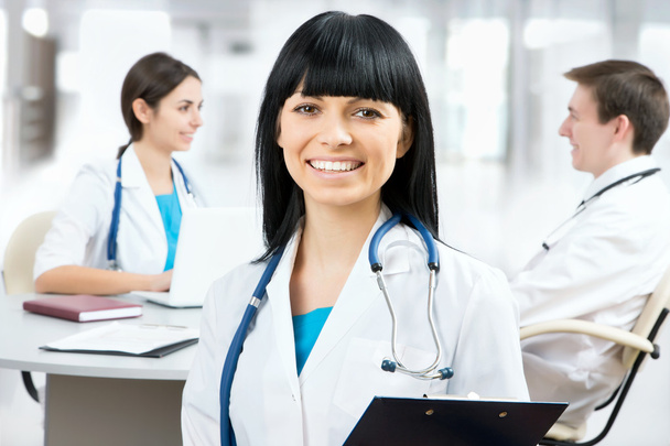 Female doctor standing in front of her team - Photo, Image