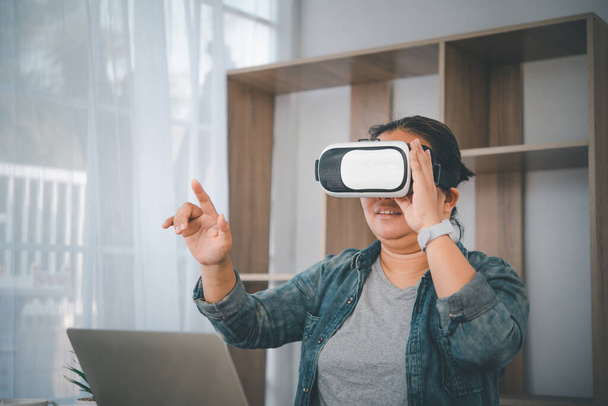 Women are using VR technology and moving their hands in the air. - Foto, Imagem