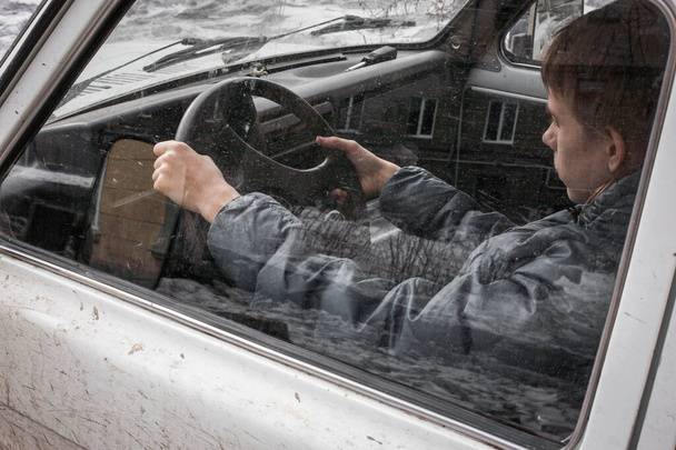 boy driving a car . boy sitting in front of the car holding steering wheel. - Fotoğraf, Görsel