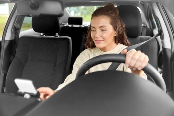 smiling woman or female driver driving car in city - Fotó, kép