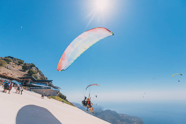 09 September 2020, Babadag, Turkey: Many brave paragliders take-off from mount Babadag near the resort of Oludeniz. The most popular place for air sports and recreation in Turkey - Fotoğraf, Görsel