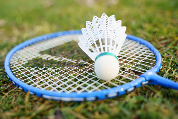 Shuttlecock and badminton racket equipment on grass - Photo, Image