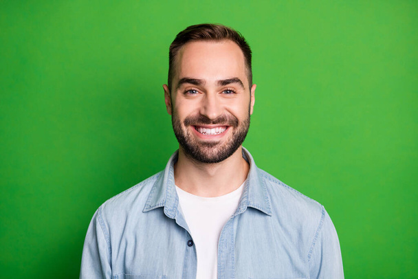 Portrait of optimistic funny man wear blue shirt isolated on green color background - Φωτογραφία, εικόνα