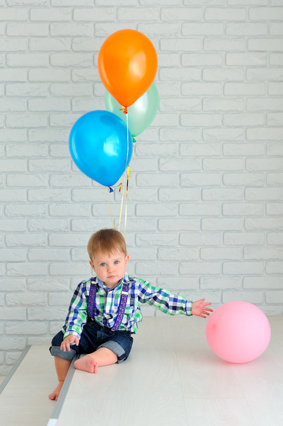 Poika värikkäiden ilmapallojen kanssa
 - Valokuva, kuva