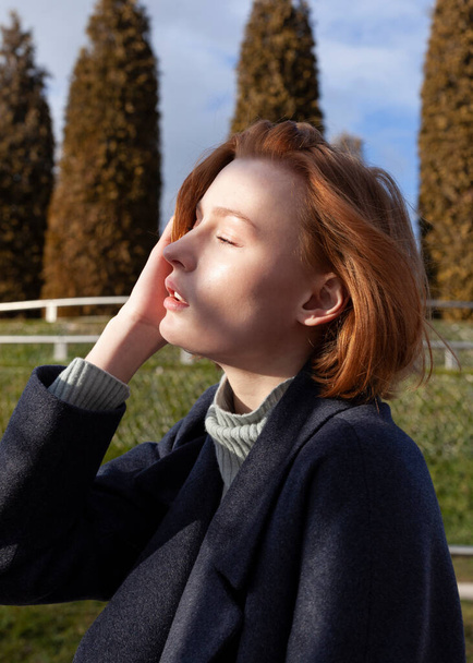 cute redhead girl walking in the park - Valokuva, kuva
