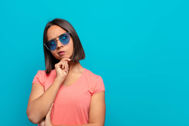 young latin woman with sun glasses and a copy space - Fotoğraf, Görsel