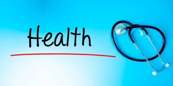 Health Sign.Text underline with red line. Isolated on blue background with stethoscope. Health concept - Photo, image