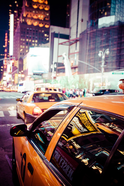 Желтый кэб мчится по Таймс-сквер в Нью-Йорке, штат Нью-Йорк, США
.  - Фото, изображение