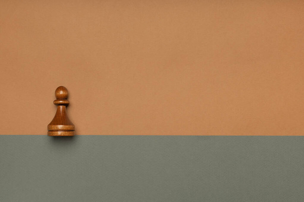 Chess pawn on flat background top view - Foto, afbeelding