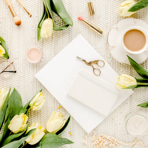 Female workspace with yellow tulip flowers, womens fashion golden accessories, diary, glasses on white background. Flat lay. Top view feminine. - Photo, image