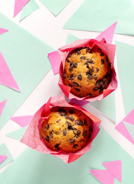 Chocolate chip muffins on a colorful geometric background - Photo, Image