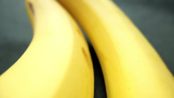 Bananen isoliert auf einem Tisch mit dunkler Tischdecke - Filmmaterial, Video