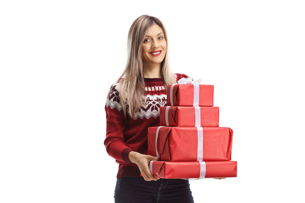 Young woman holding a pile of presents isolated on white background - Foto, Imagen