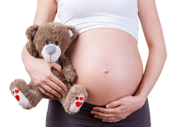 Pregnant woman with teddy bear. - Foto, Imagen