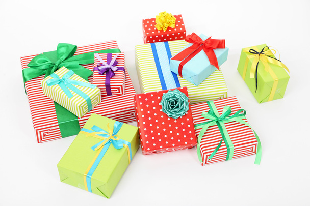 Many colorful presents with luxury ribbons  on color carpet background - Фото, изображение