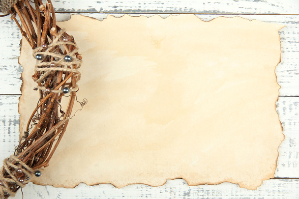 Old paper sheet and beautiful rustic wreath, on wooden background - Valokuva, kuva