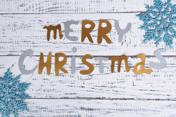Merry Christmas lettering on wooden table close-up - Foto, imagen