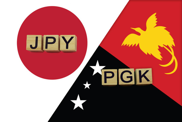Japonya ve Papua Yeni Gine para birimi kodları ulusal bayraklar üzerinde. Uluslararası para transferi kavramı - Fotoğraf, Görsel