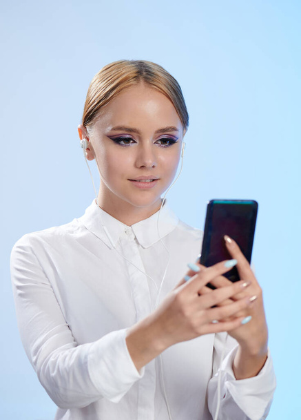 Teenager hold smartphone in front of face isolated studio background - Valokuva, kuva