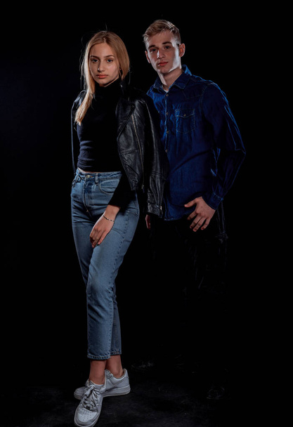 Sexy young couple dressed in trendy stylish clothes posing on cheir - Foto, afbeelding