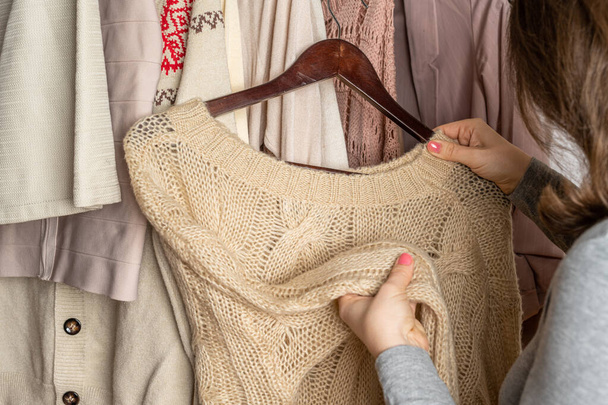 Woman shopper, customer choosing clothes. Assortment of female modern summer and autumn clothing in garment store. Shopping. - Valokuva, kuva