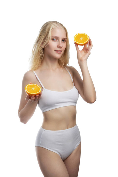 Beauty. Smiling woman with radiant face skin and orange portrait. Vitamin C cosmetics concept - Foto, immagini