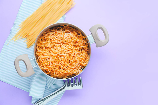 Cooking pot with pasta on color background - Photo, Image