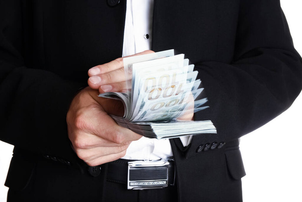 Business man holding money on white background - Foto, imagen
