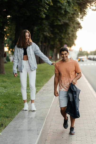 Cheerful couple enjoying walking in the city. Casual style people. Couple in love in the city. Urban lovestory. High quality photo - Photo, Image