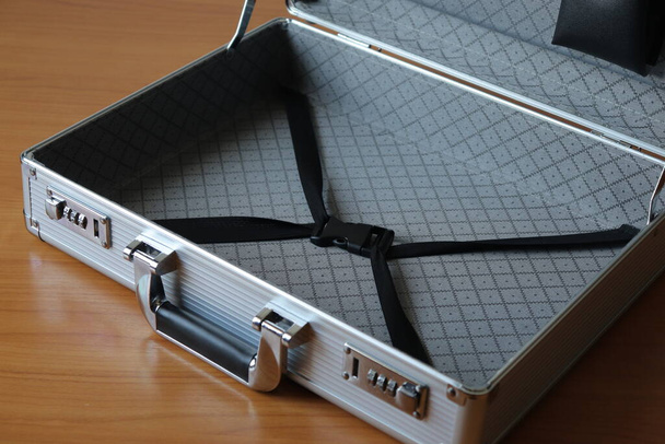 The secret briefcase is placed on the desk to hide information when moving documents or not wanting to disclose the secret layer. - Photo, Image