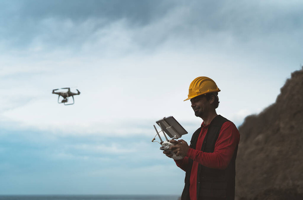 Male engineer doing inspection using drone - Technology and industrial concept - Photo, Image