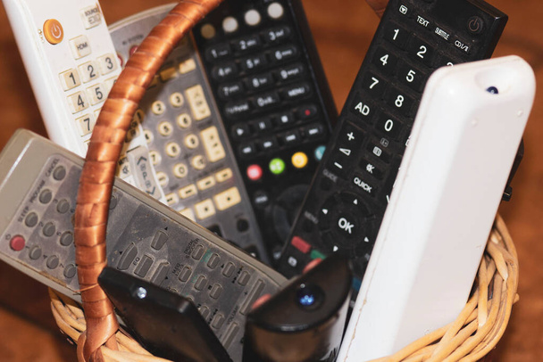 Manual remote controls for audio and video equipment in the basket - 写真・画像