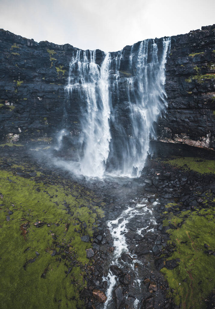 Aerial view of Fossa Waterfall, the highest waterfall in the Faroe Islands. This double-tiered waterfall is 459 feet high and cascades down into the sea. - Photo, image