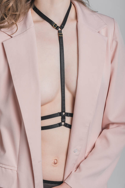 Female slim figure in underwear, straps and a jacket. Fashion shooting concept - Fotografie, Obrázek