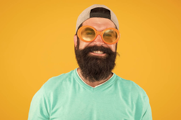 Fun and entertainment. casual hipster outfit. funny man having fun. bearded guy in party glasses. just like a freak. he is going crazy. summer male fashion. happy and smiling hipster - Фото, зображення