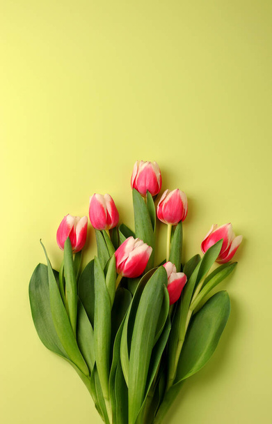 Spring concept, bouquet of tulip flowers on a light background. Women's day, Valentine's day concept, Mother's Day. Vertical position. Flat lay. Copy space - Foto, imagen