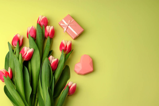 Tulips bouquet, pink heart, gift boxes on a light background. Festive concept for Valentine's Day, Mother's Day, Women's Day and Birthday. Flatlay, copy space - Φωτογραφία, εικόνα