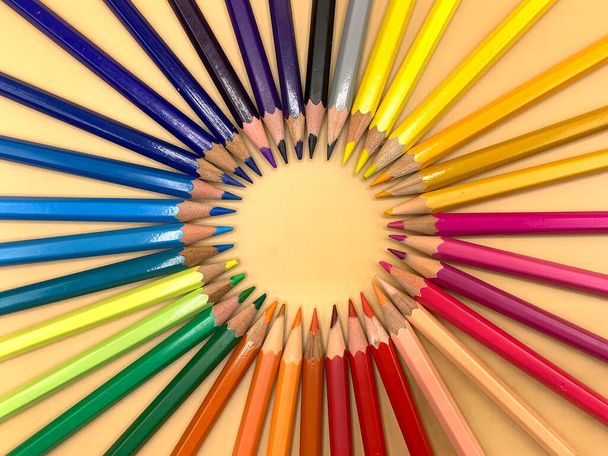 Colored pencils placed in a circle, empty space to place text - Photo, Image