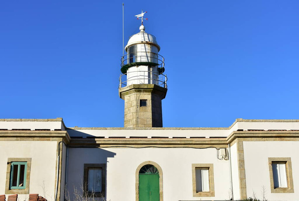 Faro de Larino or Larino Lighthouse at Punta Insua in Rias Baixas Region. Coruna, Galicia, Spain. - Photo, Image
