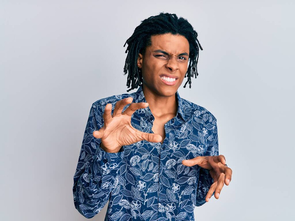 Hombre afroamericano joven con camisa de estilo 80 expresión repugnante, disgustado y temeroso haciendo cara de asco porque la reacción de aversión. con las manos levantadas  - Foto, imagen