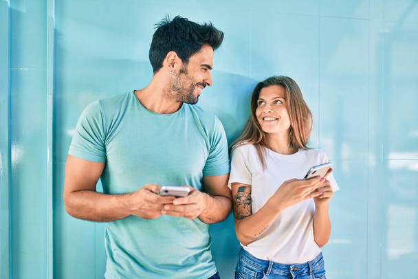 Young couple of boyfriend and girlfriend together using smartphone - Фото, изображение