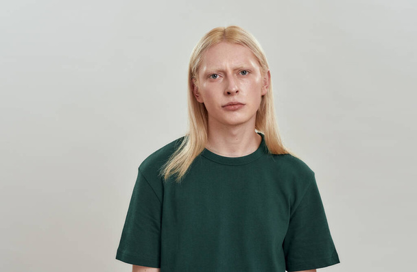 Portrait of unhappy young caucasian fair hair male model - Фото, изображение