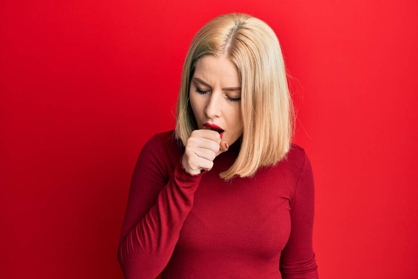 Young blonde woman wearing casual clothes feeling unwell and coughing as symptom for cold or bronchitis. health care concept.  - Photo, Image