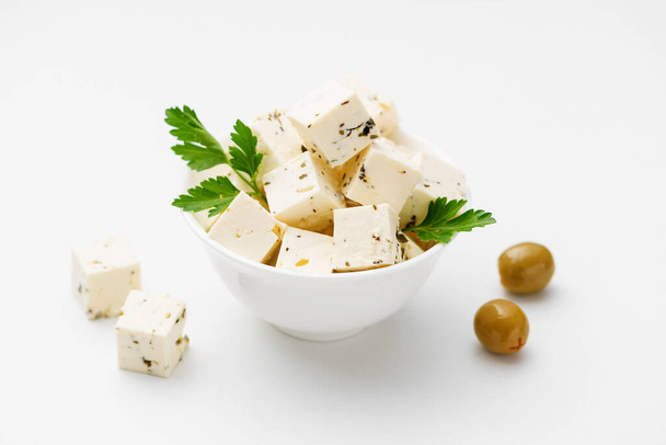 Bowl of diced soft feta cheese  on white background - Photo, Image
