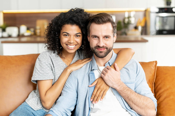 Multiracial couple in love on the couch - Fotografie, Obrázek
