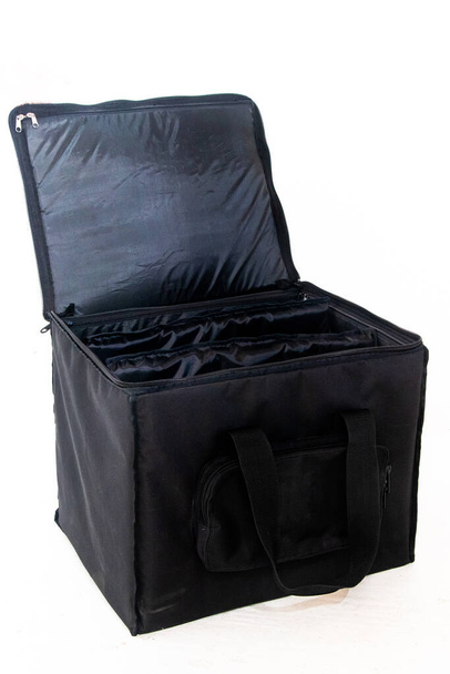 A closeup shot of a black open luggage bag with a side pocket on the white background - Foto, imagen