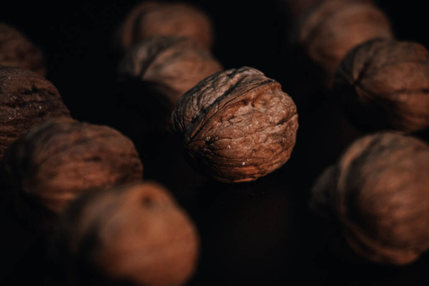 The walnuts on a dark wooden table - 写真・画像