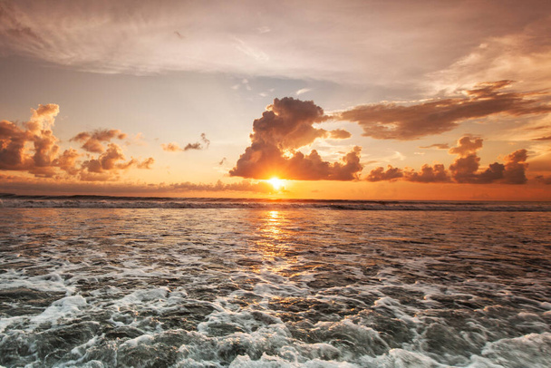 Colorful ocean beach sunset, cloudy sky and sea surf - Zdjęcie, obraz