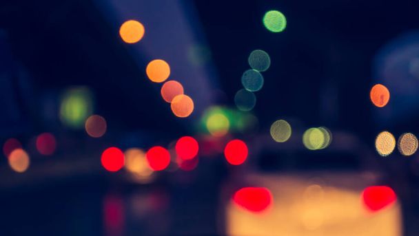 vintage tone blur image of inside cars with bokeh lights from traffic jam on night time for background. - Photo, Image